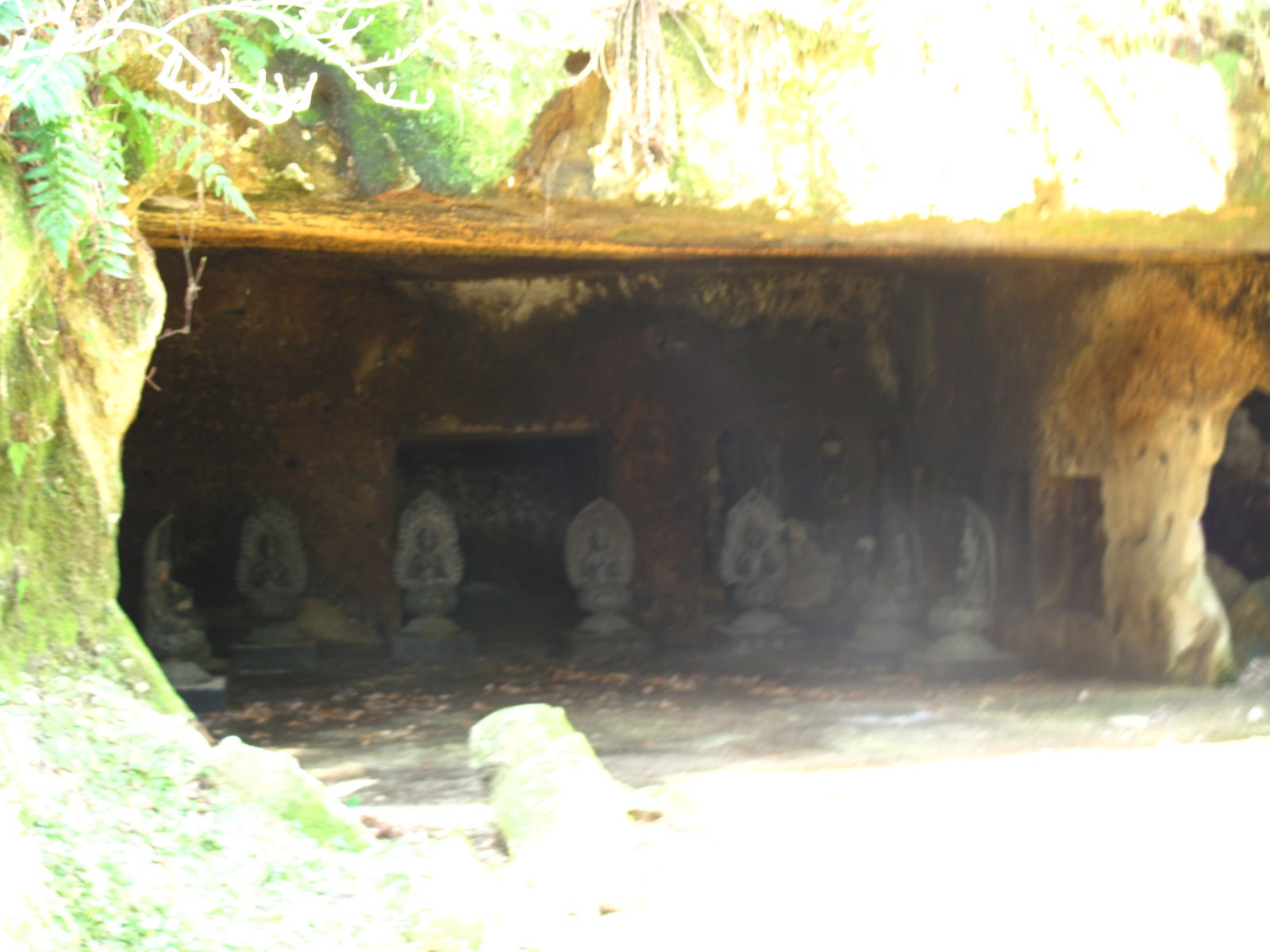 A row of small statues inside a cave