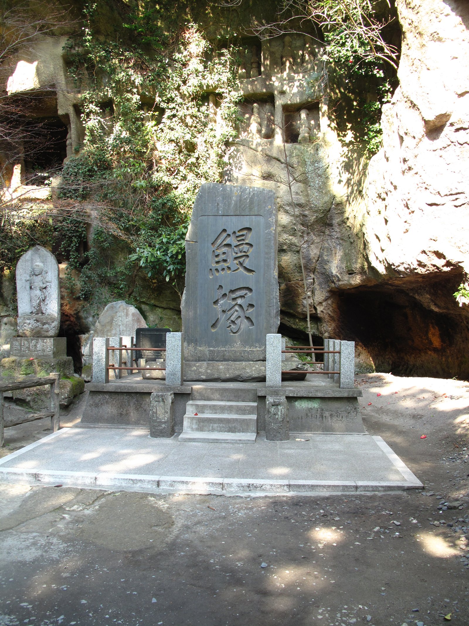Old memorial stones in front of a cave