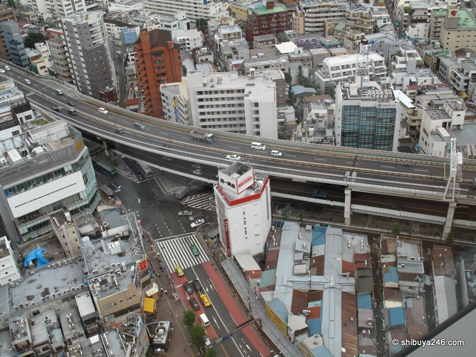 An elevated highway curving between buildings