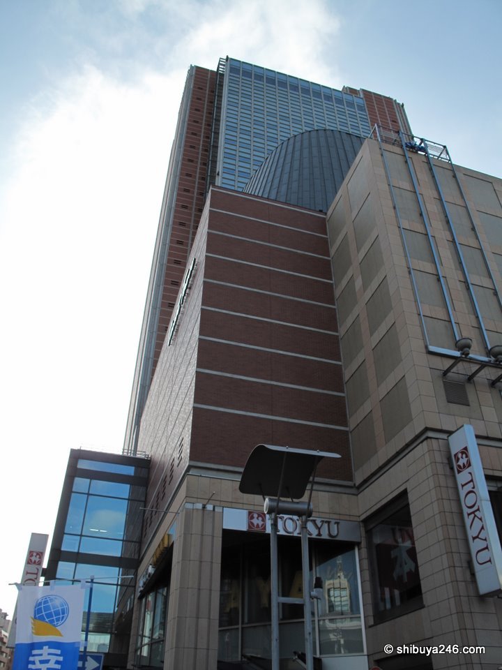 The brown Carrot Tower building seen from below
