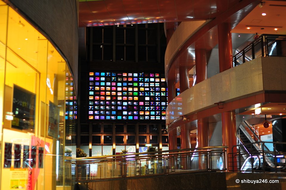 A colourful building with a grid of lit windows