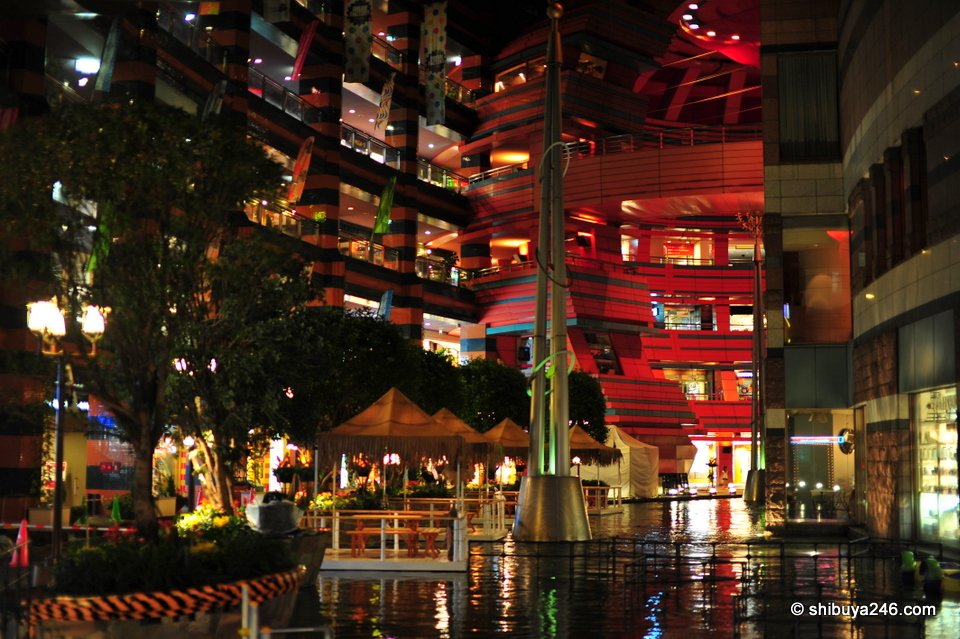 A courtyard full of lights and people at night