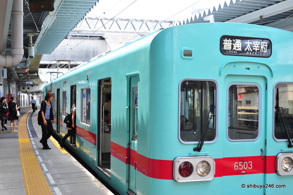 The front of a green and red train