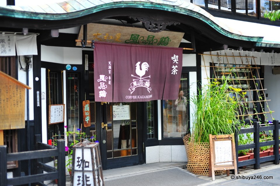 A traditional shopfront with a purple noren curtain