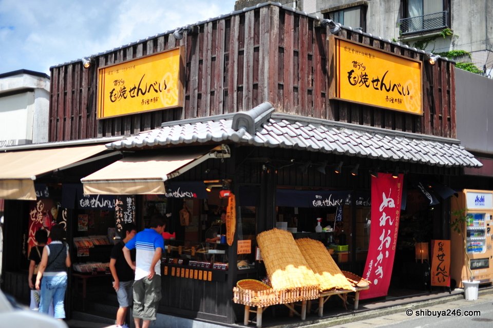 A wooden corner shop with a yellow sign