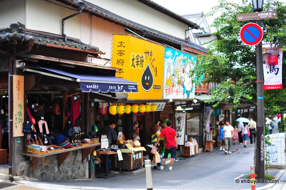 Snack stalls with yellow banners and people sitting outside