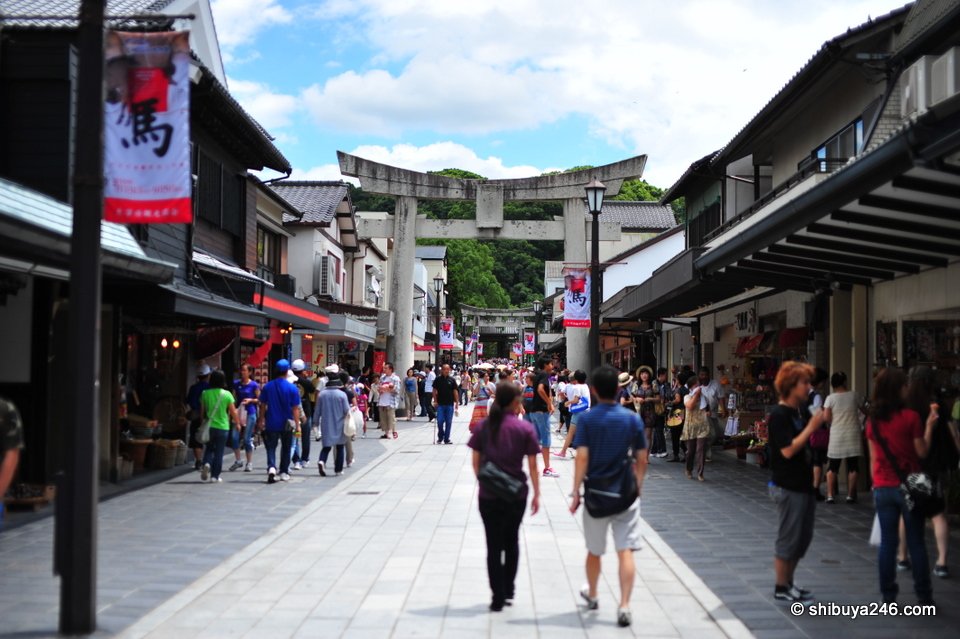 A busy street with a torii at the far end
