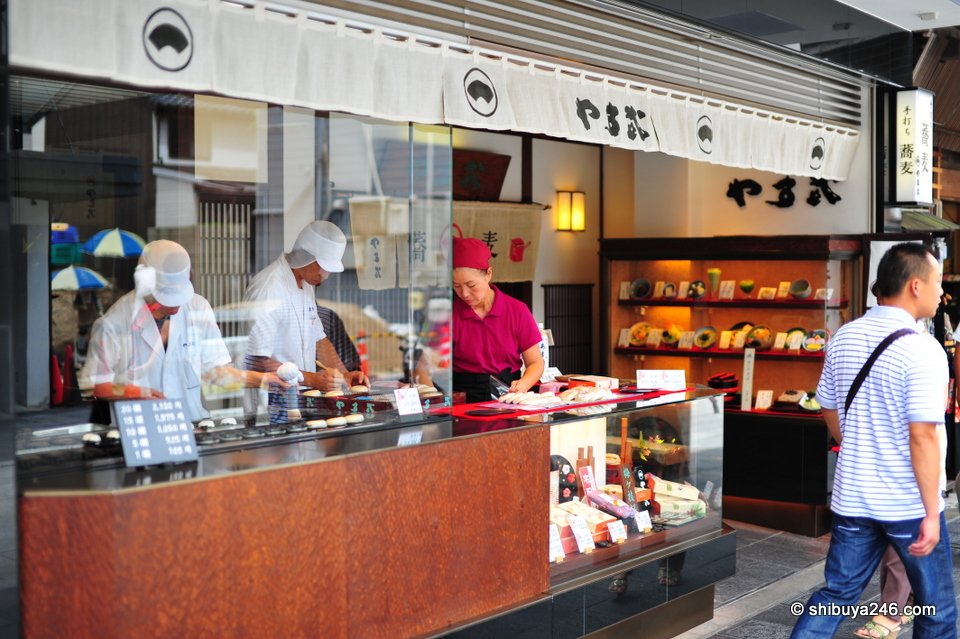 Staff making rice cakes in a shop window