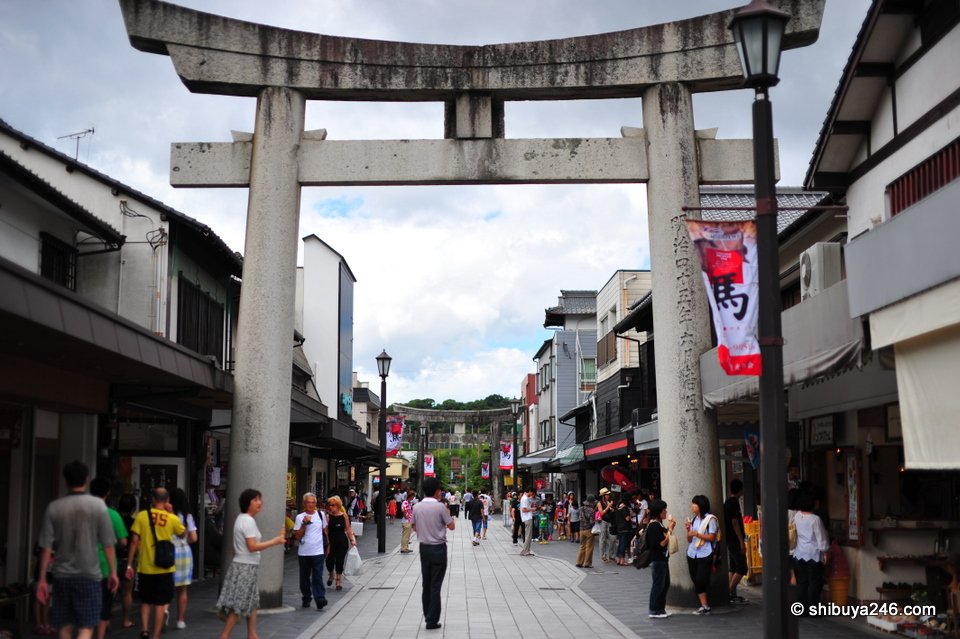 A stone torii over the shopping street