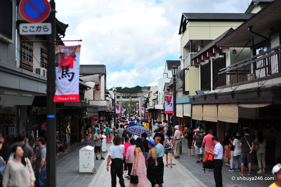 A crowded shopping street with banners