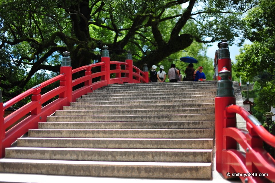 A red arched bridge with stone steps