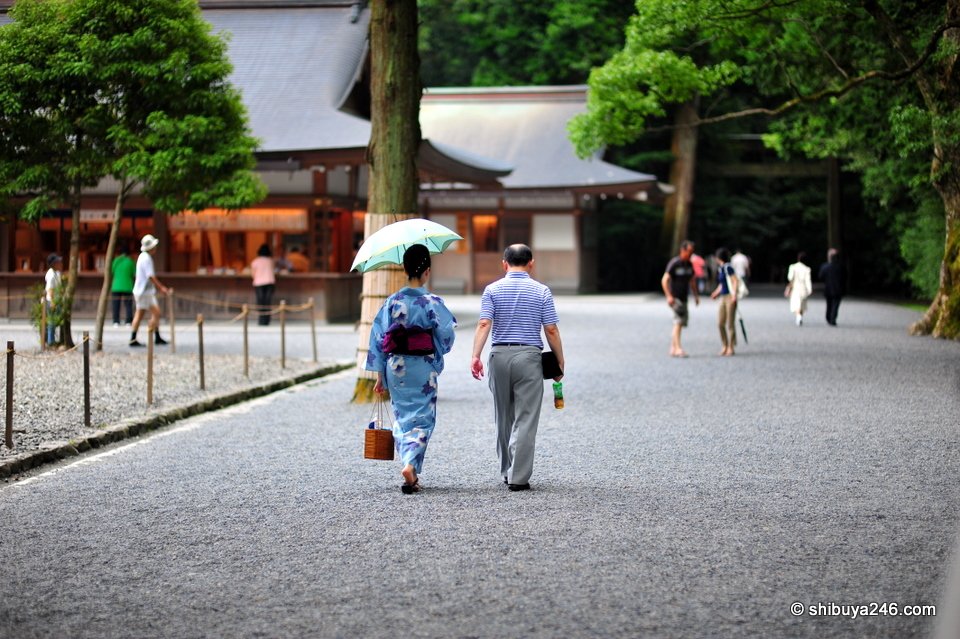 A couple in summer clothes walking across the gravel