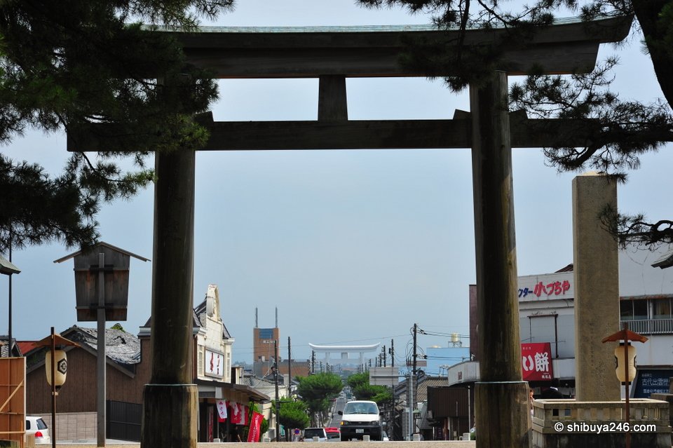 A large wooden torii beside a street