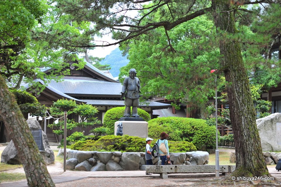 Bronze statues in a garden beside the path