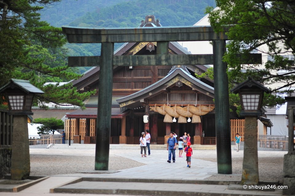 A dark bronze torii in front of the worship hall