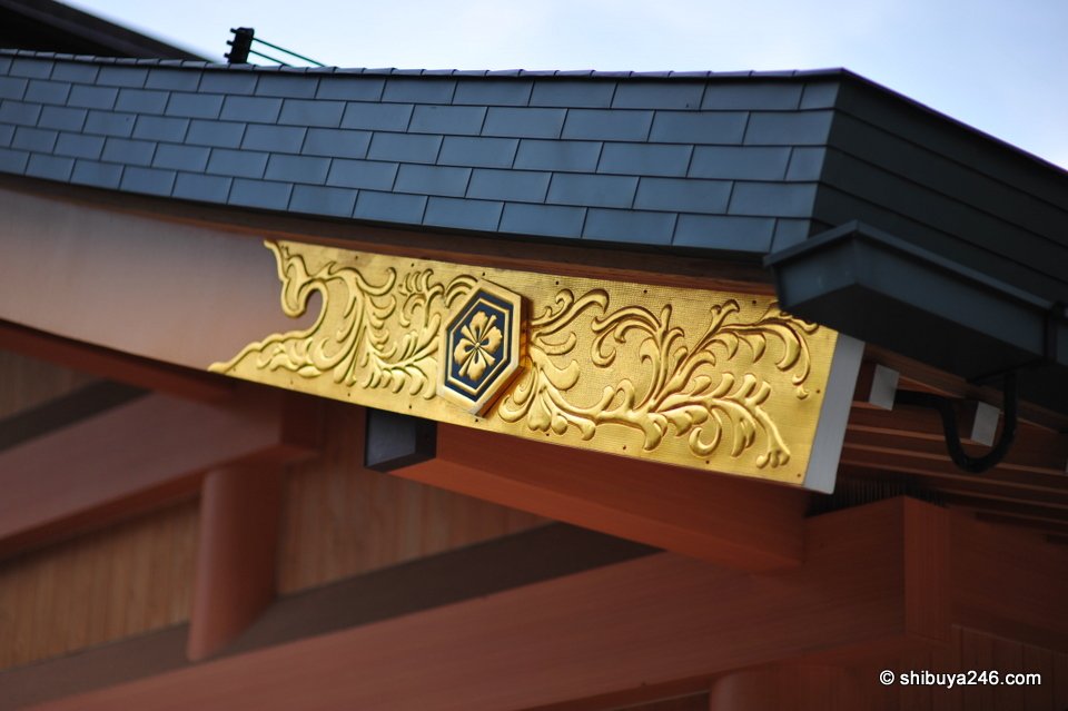A gold crest carved on a wooden beam