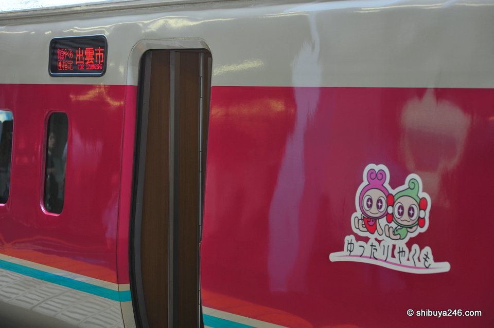 The side of a pink train with a cartoon sticker