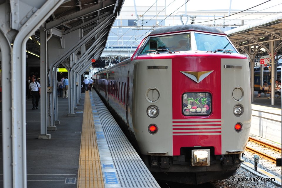 A cream and red express train at a platform