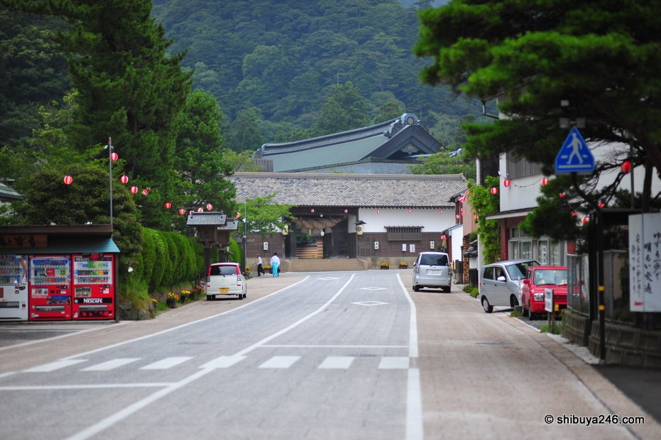 A wide road leading to a large building in the distance