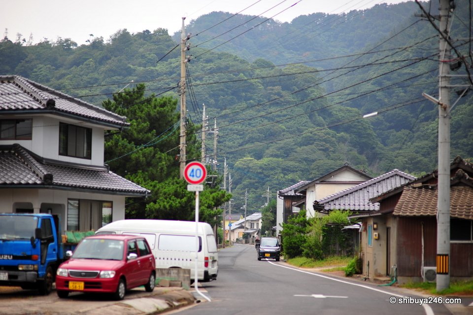 A quiet residential street with hills behind
