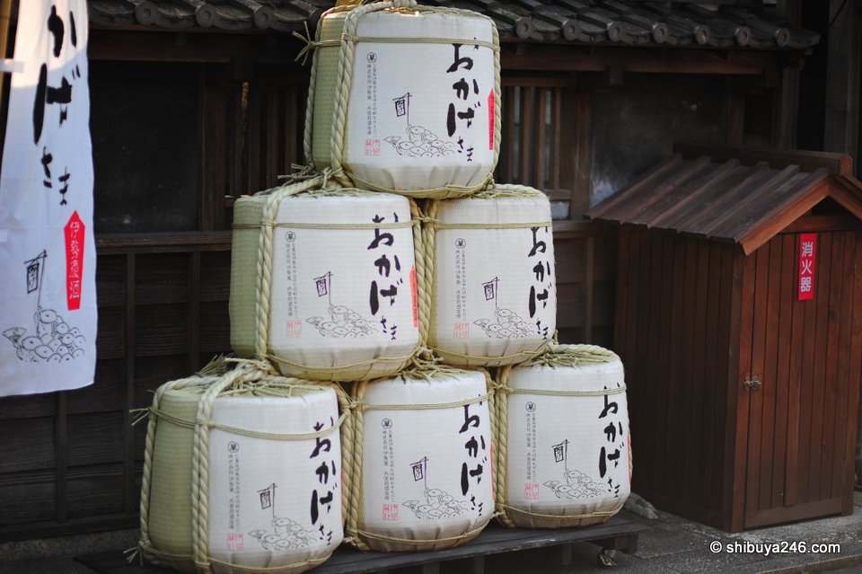Sake barrels stacked in front of a shop