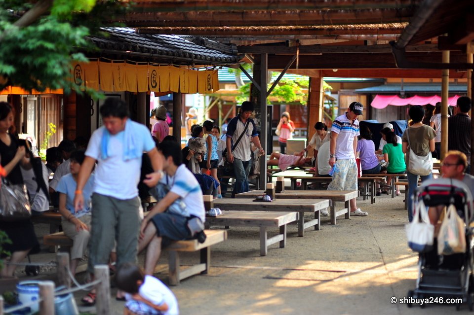 People resting at benches in a shaded courtyard