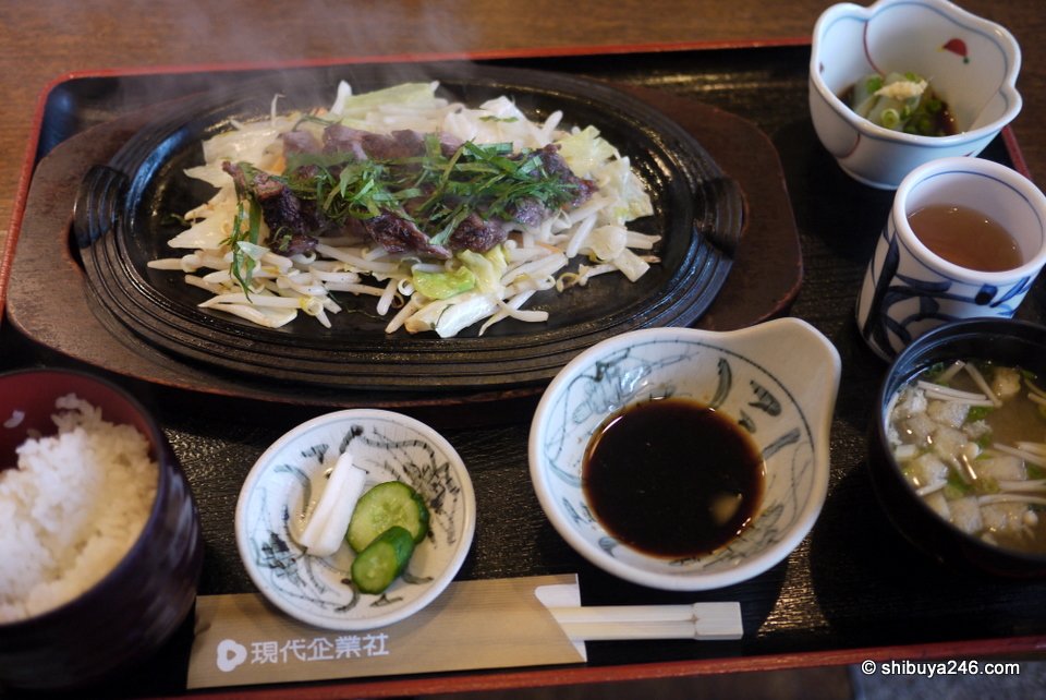 A steak set meal with rice, miso soup and pickles