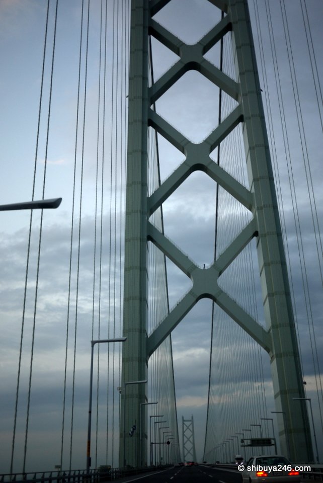 A green bridge tower seen close up from below