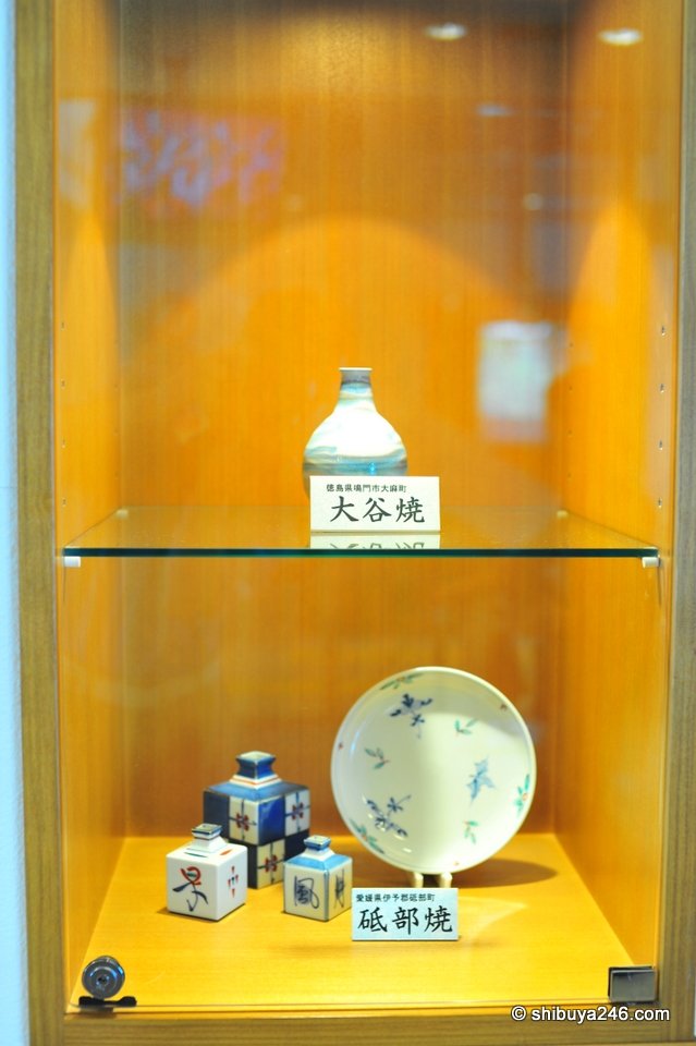 A small display case with pottery