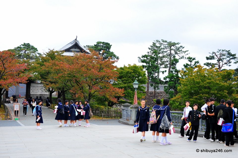 School students gathered in front of a castle gate