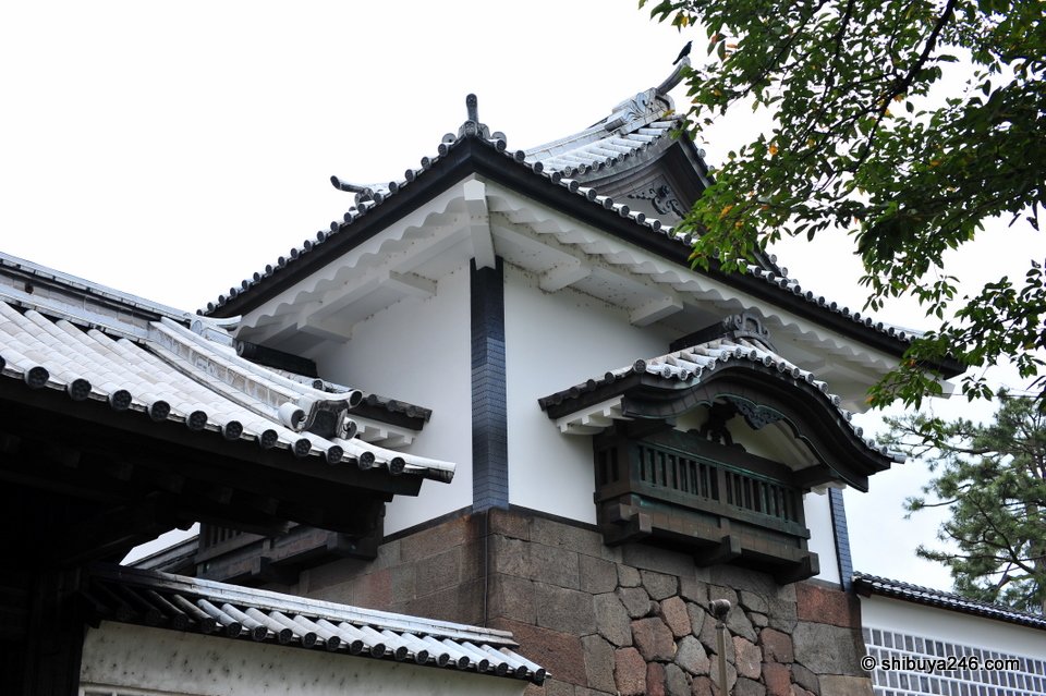 A white gatehouse with a curved roof