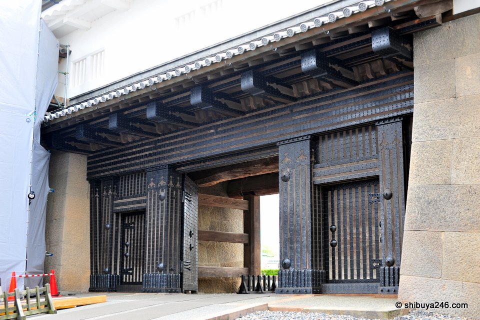 A heavy black gate with iron fittings