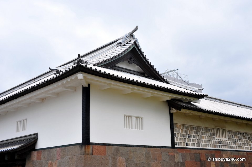 A long white castle building on a stone base