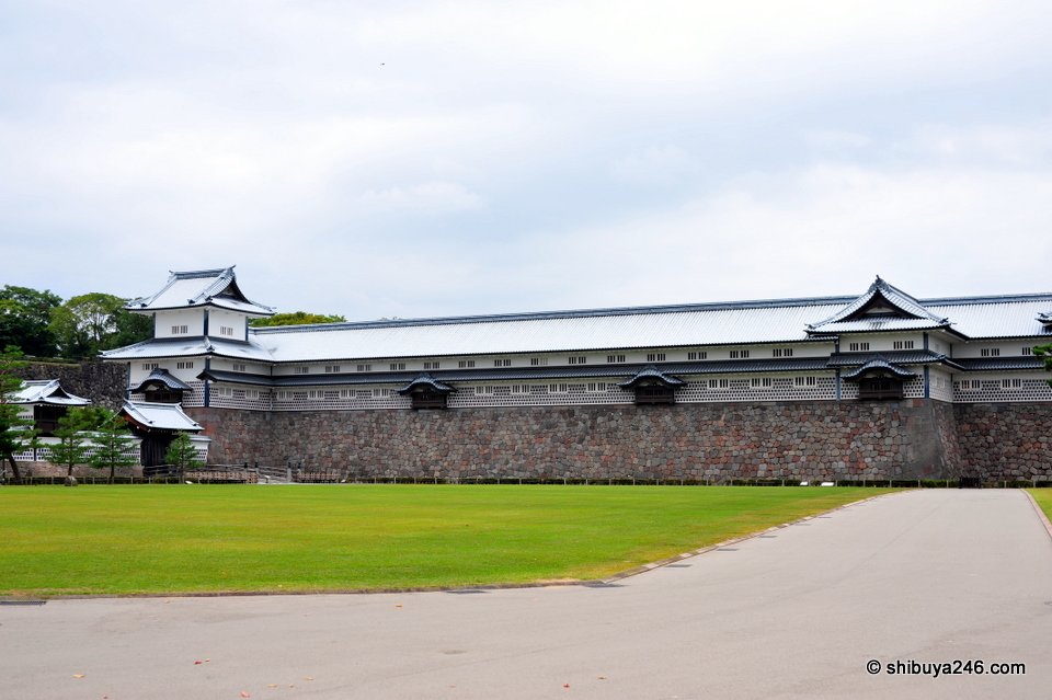 A long white castle building across a lawn
