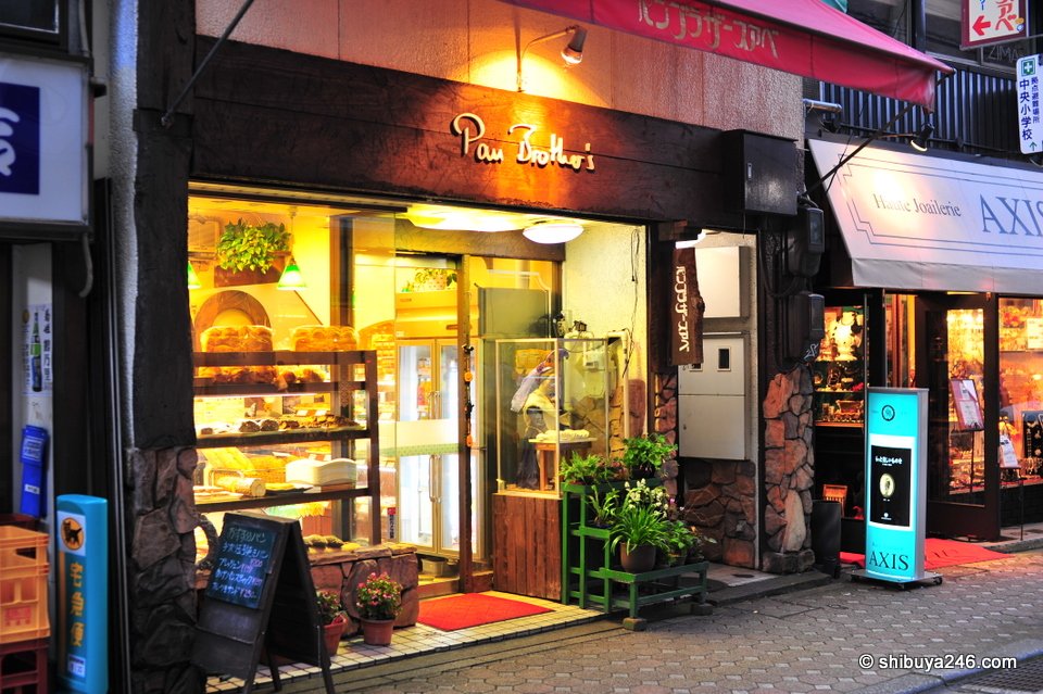 A brightly lit shopfront in the evening