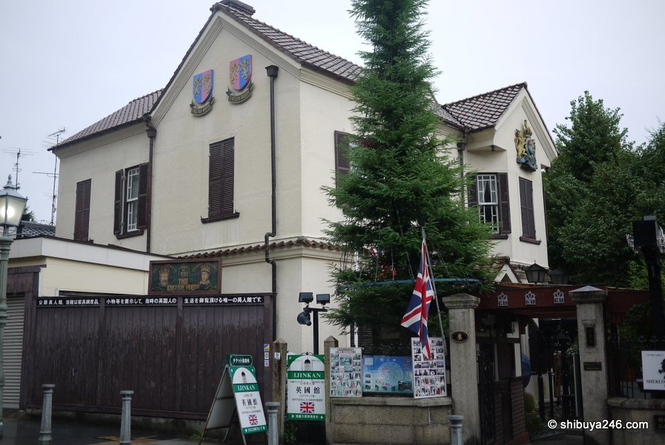 A cream Western-style house with a British flag