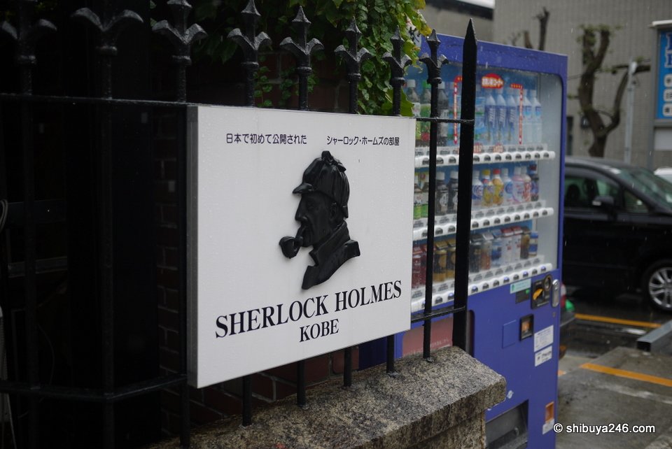 A Sherlock Holmes sign beside a vending machine