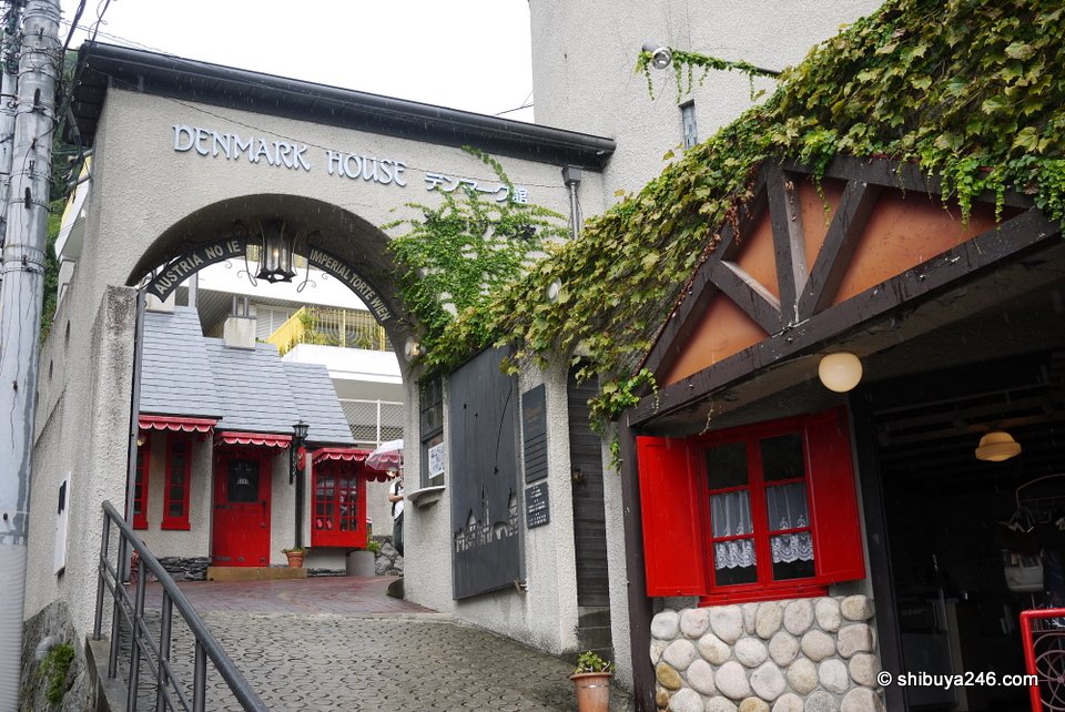 An arched entrance to a small courtyard of shops