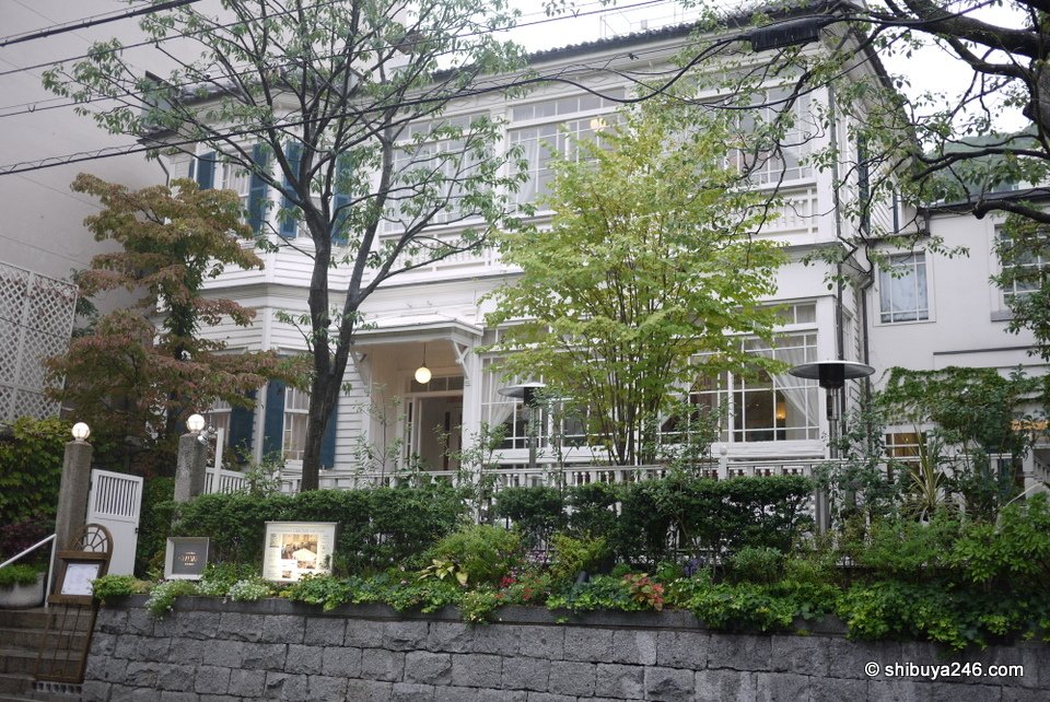 A white Western-style house behind a garden