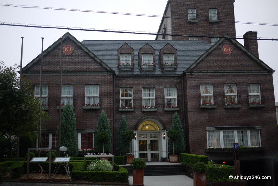 A dark brick building with a tower