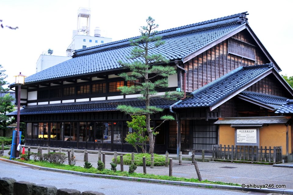 A large old wooden building with a tiled roof