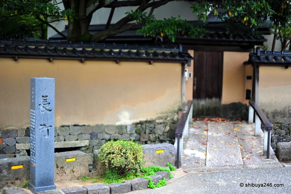 A stone marker beside a gate in an earthen wall