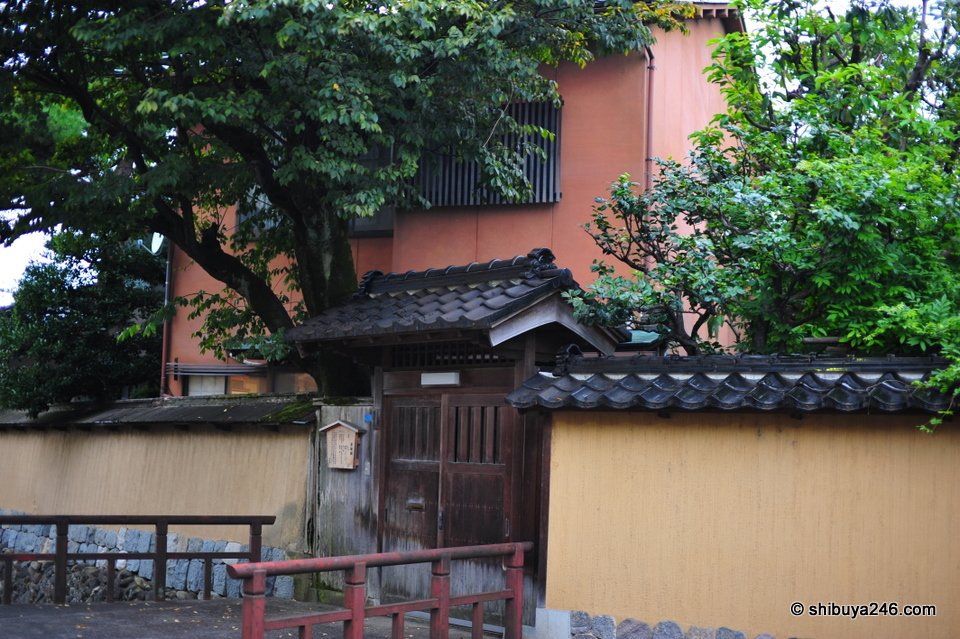 An old wooden gate with a tiled roof