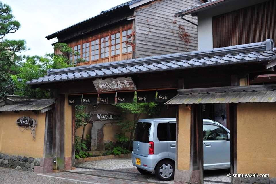 A wooden house with a tiled gate
