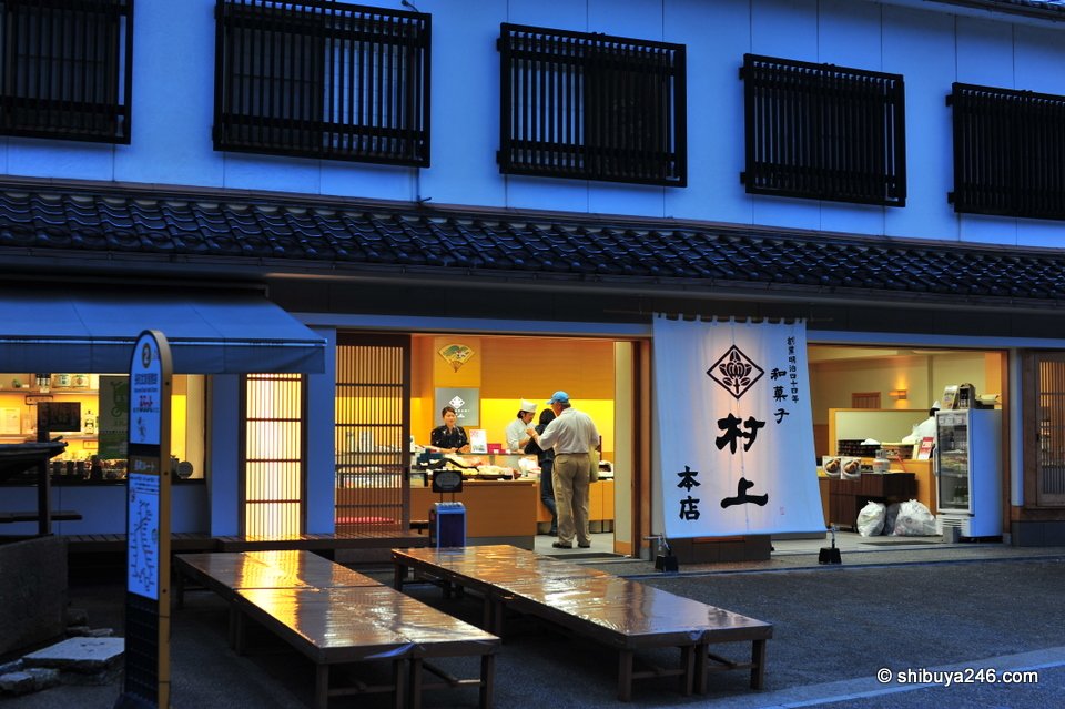 A shop with blue walls and outdoor benches