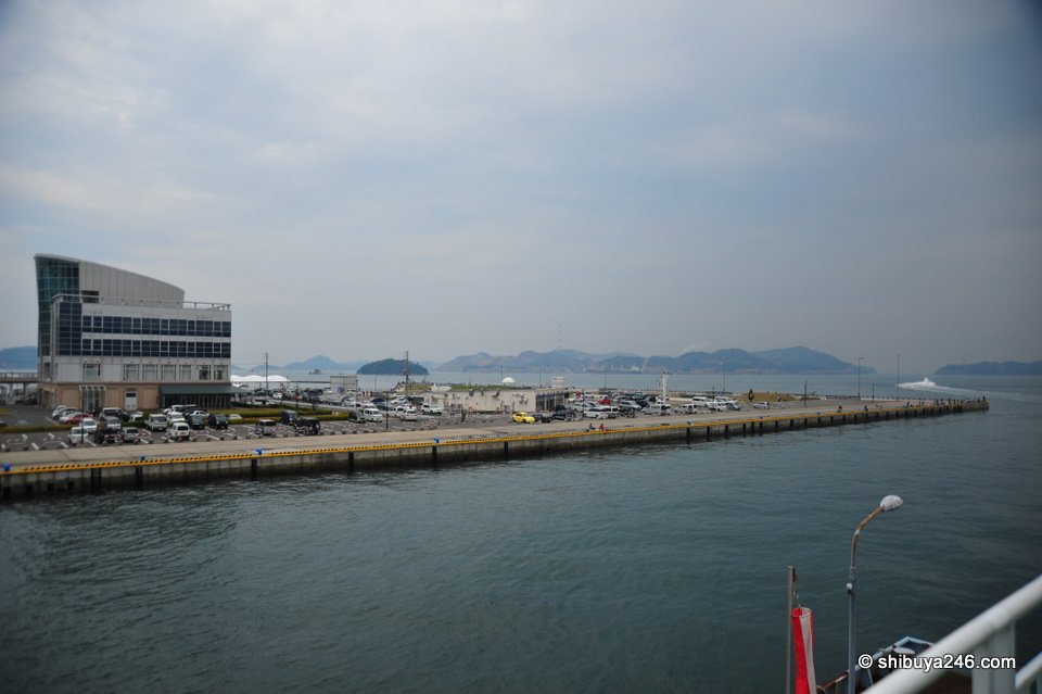 A long harbour wall and calm grey sea