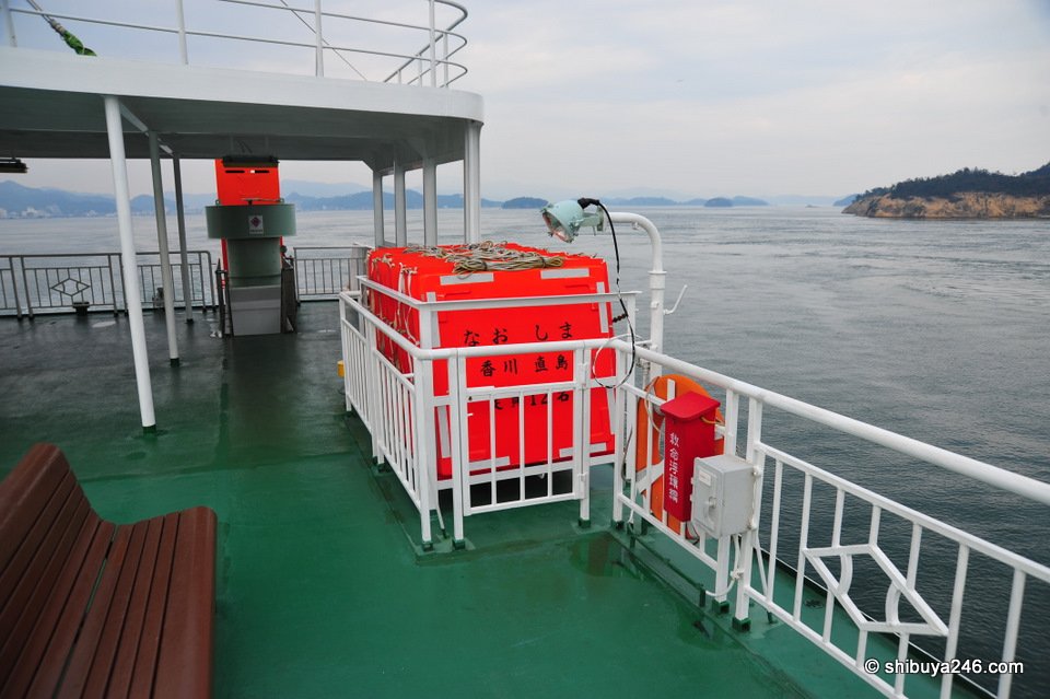 Red life raft containers on the ferry deck