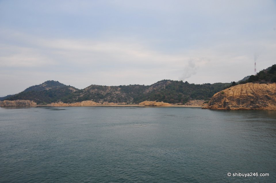 A wooded island with rocky cliffs