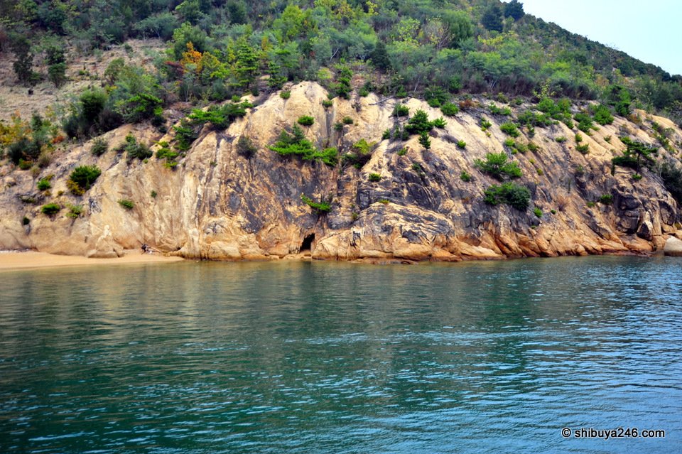 A rocky cliff face close to the water
