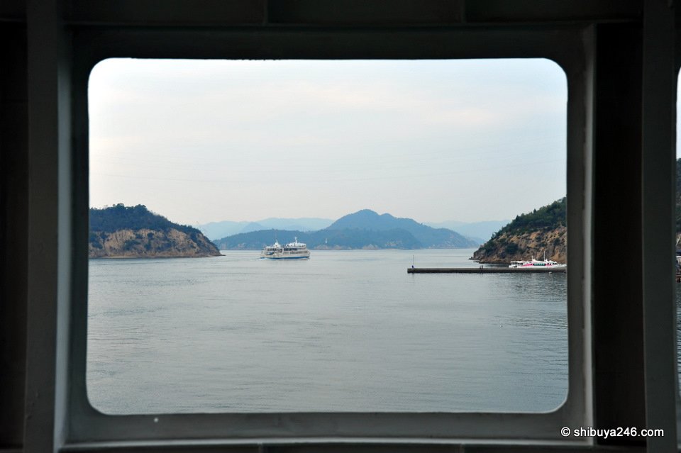 The sea and islands framed through a dark window